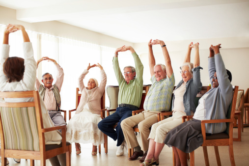 seniors stretching in an exercise class at a senior living community
