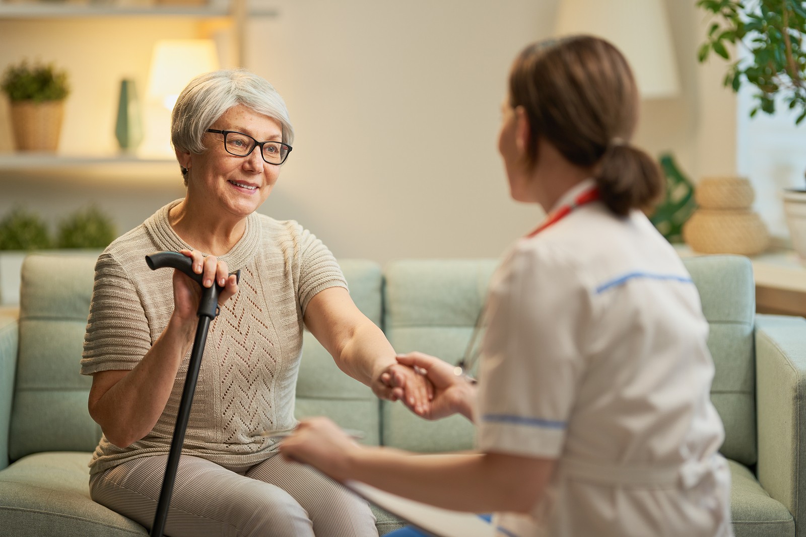 Senior woman talking with her caregiver or nurse.