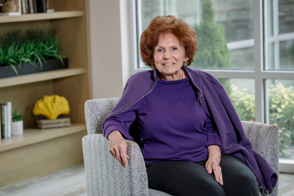 Senior woman with red hair in purple shirt and shawl
