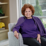 Senior woman with red hair in purple shirt and shawl