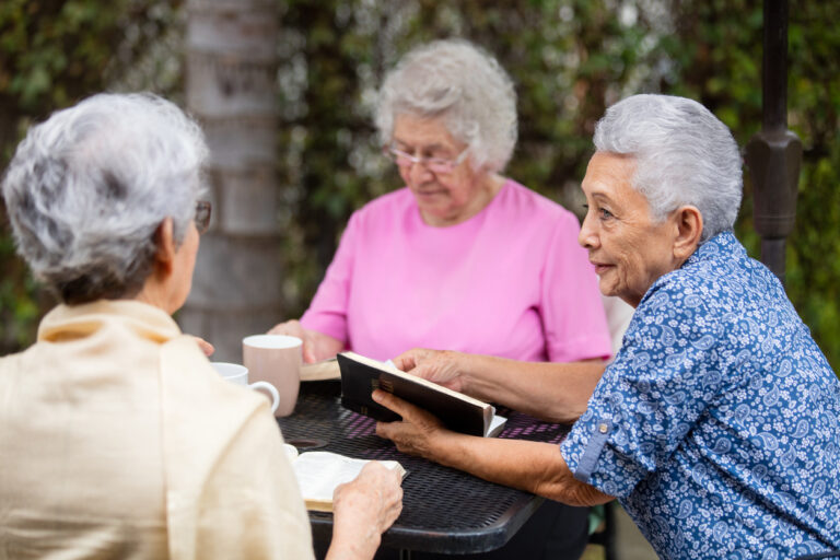 Elderly women reading together