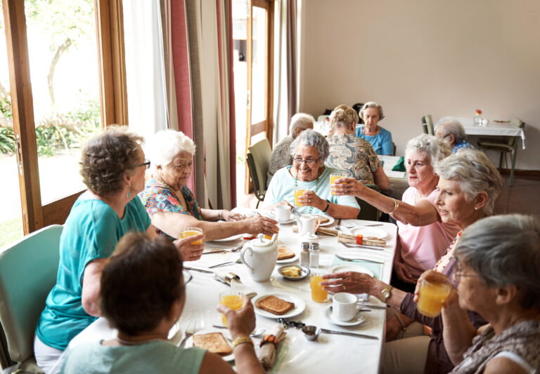 Shot of a group of seniors enjoying breakfast together in their retirement home