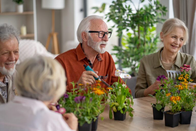 A close-knit group of seniors passionately tending to their flowers in pots, reflecting a sense of community and shared passion for gardening.