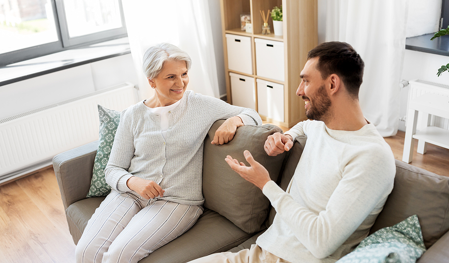 Senior mom and adult son discuss the benefits of living in a senior community