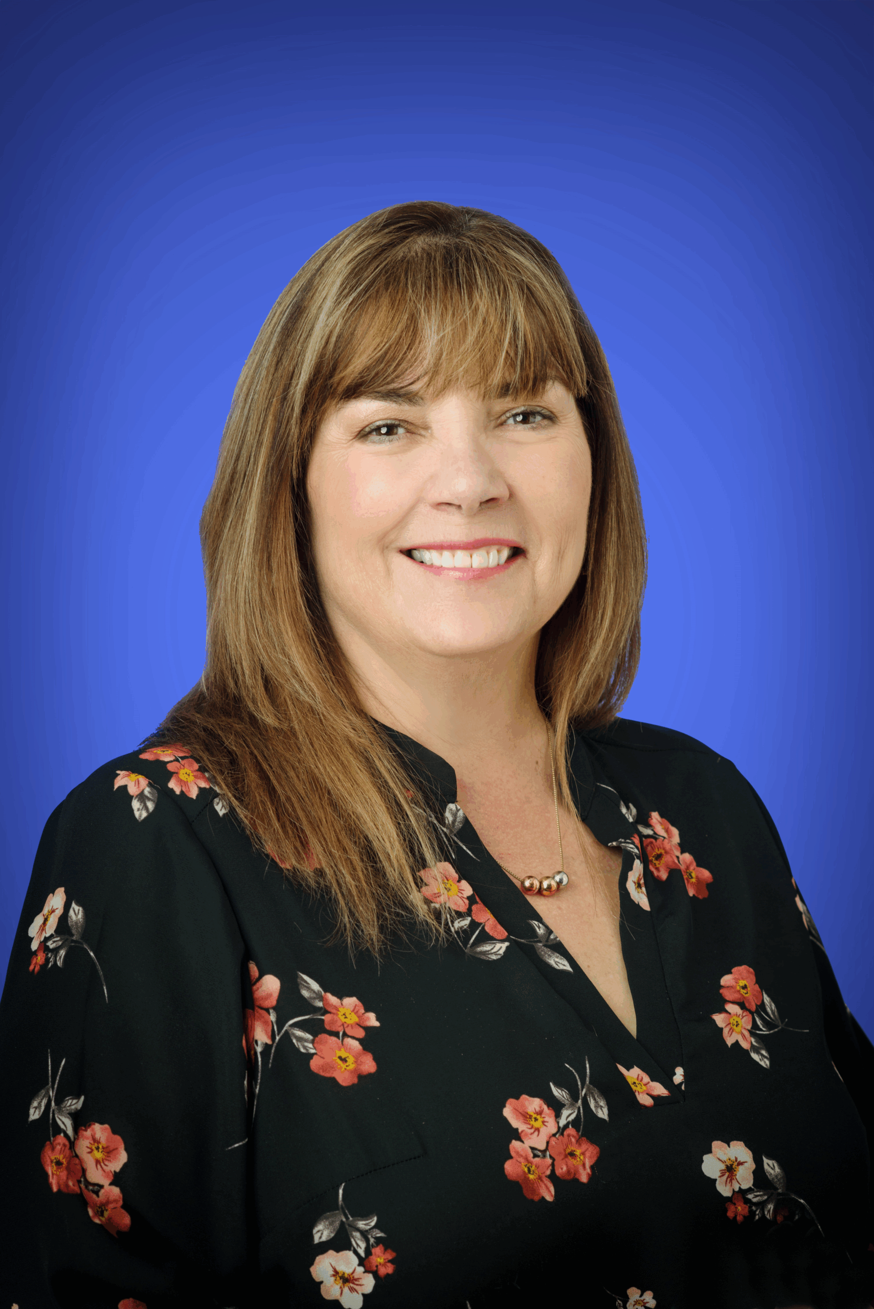 woman in floral dress shirt headshot