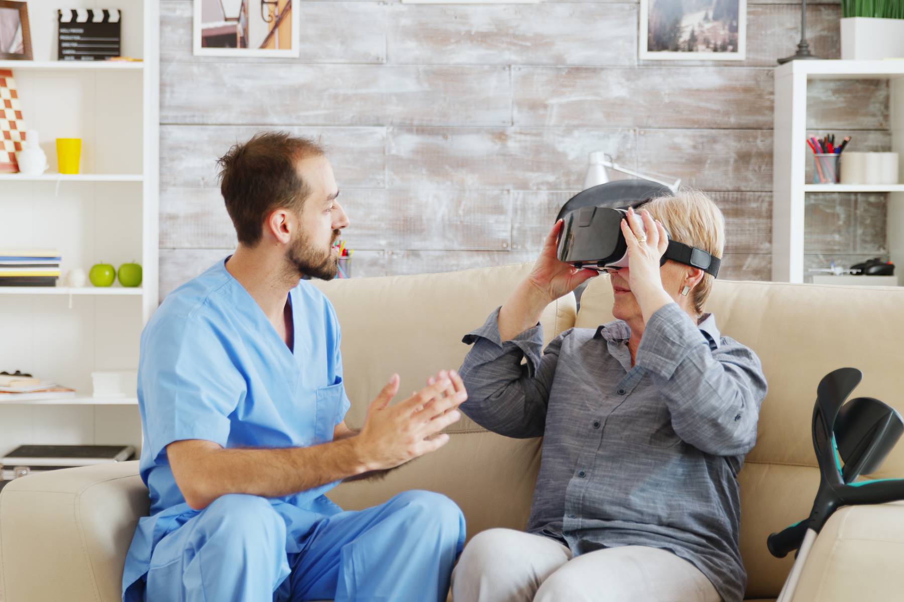 senior in memory care with virtual reality goggles on